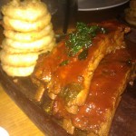 Heritage Baby Back Ribs w/tangerine BBQ sauce and tempura onion rings